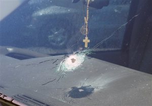 This undated photo released by the Arizona Department of Public Safety shows a bullet hole in the windshield of a vehicle in Phoenix. Four vehicles traveling on the same freeway in the heart of Phoenix have been struck by gunshots in the last week, and the state police agency is appealing for information from the public as it conducts what it says is a robust investigation. (Arizona Department of Public Safety via AP)