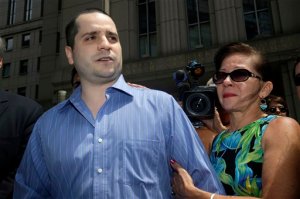 FILE - In this July 1, 2014, file photo, with his mother Elizabeth Valle by his side, GIlberto Valle, left, makes a short statement to the assembled media as he leaves Manhattan federal court in New York.  Its clearly illegal to hack into someone elses computer network and steal information from it. But what about a police officer who uses his own departments computer database to look up women from his past? A federal appeals court in New York is weighing the issue in the case of Gilberto Valle, a former New York City police detective dubbed the "cannibal cop" for his online exchanges about kidnapping and eating women. Though a judge dismissed most of the case, Valle is appealing his conviction for using an NYPD database to look up women he targeted. His supporters say that action could not have been a crime because, as an officer, he was entitled to access the database. (AP Photo/Seth Weng)