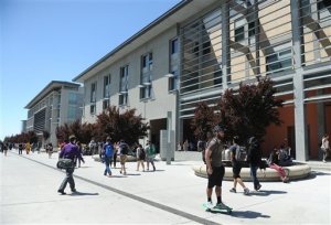 In this April 13, 2015 photo provided by the The Hechinger Report, students walk among campus buildings at University of Califoria, Merced in Merced, Calif. Pushed by politicians who represented the San Joaquin Valley in Californias farm-dominated heartland, the university is one of several public campuses that have opened in states like Florida and Arizona only to face deep cuts in higher-education budgets. (Bea Ahbeck Casson/The Hechinger Report via AP)