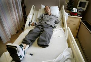 FILE--In this Dec. 9, 2014 file photo, Steve Constantine, who suffered a near fatal dog mauling in October of 2014 is shown in a hospital bed in Detroit. Derick Felton, a Detroit dog owner who pleaded guilty in the brutal mauling of a man who was attacked while feeding a pack of pit bulls, faces sentencing Friday, Sept. 24, 2015. Constantine lost most of his left arm, his left leg below the knee and his left ear last fall. (Mandi Wright/Detroit Free Press via AP)  DETROIT NEWS OUT; TV OUT; MAGS OUT; NO SALES; MANDATORY CREDIT DETROIT FREE PRESS