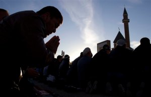 FILE - In this Tuesday, Oct. 15, 2013 file photo Muslims pray outside a mosque during celebrations of Eid al-Adha, a feast celebrated by Muslims worldwide, which Muslims in Russia call Kurban-Bairam, in Moscow, Russia, The plunge in the Russian ruble has made travelling abroad hugely more expensive. For the countrys Muslim minority that means more than just canceling a beach vacation but putting on hold the one-in-a-lifetime pilgrimage to the holy city of Mecca, in Saudi Arabia. (AP Photo/Ivan Sekretarev, File)