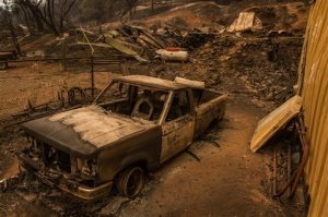 Burnt remains of a vehicle left behind remains off Jesus Maria Road near Mokelumne Hill, Calif., Friday, Sept. 11, 2015. The wildfire in Northern California that exploded in size has destroyed multiple homes in Amador County as evacuations remained in place Thursday, Cal Fire officials said. (Andrew Seng/The Sacramento Bee via AP)  MAGS OUT; LOCAL TELEVISION OUT (KCRA3, KXTV10, KOVR13, KUVS19, KMAZ31, KTXL40); MANDATORY CREDIT