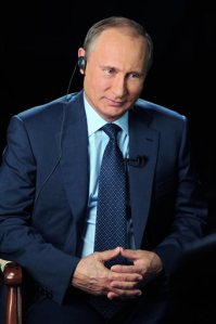 In this Sunday, Sept. 20, 2015 photo released on Monday, Sept. 28, 2015 by the Kremlin press service, Russian President Vladimir Putin smiles as he listens to a question during an interview with CBS and PBS in Moscow, Russia. (Mikhail Klimentyev/RIA-Novosti, Kremlin Pool Photo via AP)