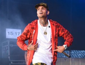FILE - In this June 7, 2015 file photo, rapper Chris Brown performs at the 2015 Hot 97 Summer Jam in East Rutherford, N.J. A judge in Houston on Friday, Sept. 11, awarded Brown joint custody of his 16-month-old daughter Royalty, with the childs mother, Nia Guzman. The child was born in Houston. (Photo by Scott Roth/Invision/AP, File)