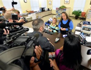 Rowan County Clerk Kim Davis, right, talks with David Moore following her office's refusal to issue marriage licenses at the Rowan County Courthouse in Morehead, Ky., Tuesday, Sept. 1, 2015. Although her appeal to the U.S. Supreme Court was denied, Davis still refuses to issue marriage licenses. (AP Photo/Timothy D. Easley)