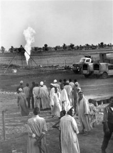 FILE - In this Nov. 25, 1966 file photo, farmers look at a towering flame at an outburst of natural gas, discovered by the Italian oil company ENI in the Nile Delta region of Kafr el-Sheikh, Egypt. Italian energy company Eni SpA said Sunday, Aug. 30, 2015, that it found the largest-ever gas field in the Mediterranean Sea off Egypts shores. Egypts new natural gas bonanza is causing an uproar in Israel, with energy stocks plummeting and recriminations over dithering and infighting that has delayed production from the countrys own gas fields. (AP Photo/Aly Mahmoud)