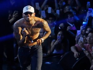 FILE - In this July 25, 2015 file photo, Grammy award-winning singer Chris Brown performs at a club in Macau. A government minister signaled Thursday, Sept. 24, 2015 that troubled R&B singer Chris Brown won't be allowed to tour Australia in December because of his criminal conviction for assaulting pop star Rihanna. (AP Photo/Kin Cheung, File)