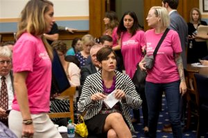 As supporters of Planned Parenthood looks for seats, Melissa Ohden, center, pro-life supporter from Gladstone, MO., waits to testify before the House Judiciary Committee hearing at the Capitol in Washington examining the abortion practices of Planned Parenthood.