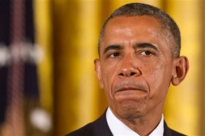 FILE - In this July 21, 2014 file photo, President Barack Obama pauses as he speaks before signing executive orders to protect LGBT employees from federal workplace discrimination in the East Room of the White House in Washington.  The Obama administration has proposed to ban discrimination against transgender people throughout the health care system, carrying out anti-bias provisions in the president's health overhaul.   (AP Photo/Jacquelyn Martin)