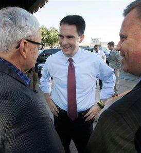 Republican presidential candidate Wisconsin Gov. Scott Walker, center, greets supporters during a meet and greet visit to the Highland Park Soda Fountain in Dallas, Wednesday, Sept. 2, 2015. (AP Photo/LM Otero)