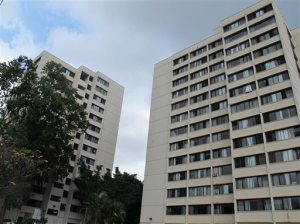 The Hale Wainani dormitory is seen at the University of Hawaii in Honolulu on Monday, Aug. 17, 2015. Two men fell from the 14th floor of the University of Hawaii dormitory, one of them to his death while trying to pull the other from a ledge, Honolulu police said. The 24-year-old man who died was trying to bring inside an apparently distraught 19-year-old who went out a window onto the ledge early Sunday, authorities said. (AP Photo/Jennifer Sinco Kelleher)