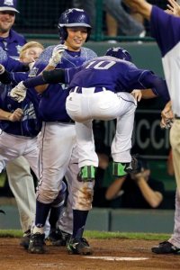 Pearland, Texas' Caleb Low (10) leaps onto home plate after hitting a two-run home run off Bonita, Calif.'s Jacob Baptista during the eighth inning of a U.S. elimination baseball game at the Little League World Series in South Williamsport, Pa., Thursday, Aug. 27, 2015. Pearland won 9-7. (AP Photo/Gene J. Puskar)