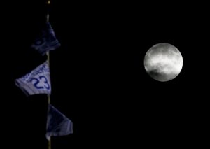 A so-called supermoon rises in the sky before a total lunar eclipse at Wrigley Field, Sunday, Sept. 27, 2015, in Chicago. It was the first time the events have made a twin appearance since 1982, and they won't again until 2033. (AP Photo/Nam Y. Huh)