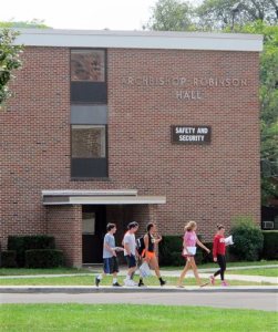 In this Aug. 29, 2015 photo, students walk past the public safety building at St. Bonaventure University in St. Bonaventure, N.Y. Students at New York state's private colleges and universities return to campus with a new, affirmative sexual consent policy to combat campus sexual violence. A bill signed by Gov. Andrew Cuomo over the summer expands on a policy in effect at public colleges which includes a "yes means yes" definition of consent requiring a clear, affirmative agreement between partners. In July, New York became the second state, after California, to write the affirmative consent standard into law for campuses.  (AP Photo/Carolyn Thompson)