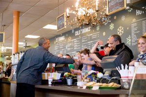 President Barack Obama visits with guests at Snow City Cafe in Anchorage, Alaska, Tuesday, Sept. 1, 2015. Obama is on a historic three-day trip to Alaska aimed at showing solidarity with a state often overlooked by Washington, while using its glorious but changing landscape as an urgent call to action on climate change. (AP Photo/Andrew Harnik)