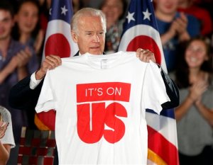 FILE - In this Sept. 17, 2015, file photo, Vice President Joe Biden holds up a shirt before speaking at an It's On Us event on the Ohio State University campus in Columbus, Ohio. Biden was speaking about the importance of preventing sexual assault on college campuses. A major new study finds that a quarter of undergraduate women at more than two dozen universities experienced unwanted sexual contact at some point during their college career. The survey by the Association of American Universities comes at a time of heightened public awareness and increased scrutiny of what schools are doing to combat sexual assault on campus. More than 150,000 undergraduate, graduate and professional students at the organizations member schools participated. (AP Photo/Paul Vernon)
