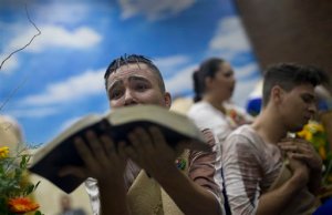 A young devotee performs while holding a Bible during a service at the Contemporary Christian Church in Rio de Janeiro, Brazil, Monday, Sept. 7, 2015. At the Contemporary Christian Church, which on Monday celebrated its ninth anniversary and the opening of its ninth branch with a raucous, theatrical service, homosexuality is celebrated rather than stigmatized. (AP Photo/Silvia Izquierdo)