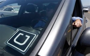 FILE - In this July 15, 2015 file photo, Uber driver Karim Amrani sits in his car parked near the San Francisco International Airport parking area in San Francisco. Hilton is hailing the ride sharing service Uber to help guests reach its hotels and then explore the city where they are staying, the companies announced Tuesday, Sept. 1, 2015. (AP Photo/Jeff Chiu, File)