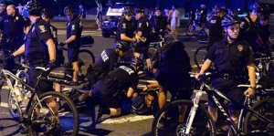A protester is arrested near Bank of America Stadium on Saturday, Aug. 22, 2015, in Charlotte, N.C. Police in North Carolina made plans Saturday for multiple activities while keeping an eye on protests following the mistrial declared in the case of a white police officer accused in the shooting death of an unarmed black man. (Jeff Siner/The Charlotte Observer via AP) MAGS OUT; TV OUT; MANDATORY CREDIT