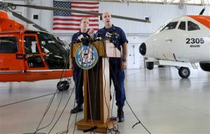 Capt. Mark Fedor, right, chief of response for the Coast Guard 7th District, talks to during a news conference as Lt. Commander Gabe Somma, left, listens, Monday, Oct. 5, 2015, at the Opa-locka Airport in Opa-locka, Fla. The Coast Guard said Monday that a U.S. cargo ship carrying 33 people that has been missing since it encountered high winds and heavy seas from Hurricane Joaquin sank and one body was found, but planes and ships will continue searching for the missing crew. (AP Photo/Alan Diaz)
