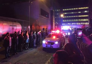 Police salute outside Harlem Hospital Center as the body of New York Police Department Officer Randolph Holder passes by in an ambulance, early Wednesday, Oc. 21, 2015, in New York. Holder, 33, died after being shot in the head in a gun battle Tuesday while pursuing a suspect following a report of shots fired, police said. (AP Photo/Michael Balsamo)