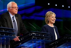 Hillary Rodham Clinton, right, smiles as Sen. Bernie Sanders, of Vermont, speaks during the CNN Democratic presidential debate Tuesday, Oct. 13, 2015, in Las Vegas. (AP Photo/John Locher)
