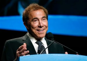 FILE - In this Jan. 15, 2015 file photo, Wynn Resorts CEO Steve Wynn delivers the keynote address at Colliers International Annual Seminar at the Boston Convention Center in Boston. Wynn, who leans Republican, is hosting the Tuesday, Oct. 13, 2015 Democratic presidential debate at his Wynn Las Vegas resort-casino. (AP Photo/Elise Amendola, File)