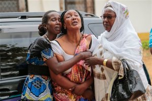 FILE--In this file photo dated Friday, July 3, 2015, relatives and friends grieve during the funeral of Patrick Ndikumana, in Bujumbura, Burundi.  Dead bodies keep turning up, dumped at roadsides and in water streams where they are discovered by people who dont recognize the victims. More than two months after President Pierre Nkurunziza was controversially re-elected, many parts of Burundi still echo with gunfire, grenade explosions and assassination attempts on prominent figures.(AP Photo/Bertheir Mugiraneza-File)