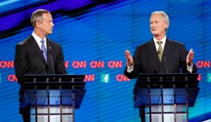 Former Rhode Island Gov. Lincoln Chafee, right, speaks as Former Maryland Gov. Martin O'Malley, looks on during the CNN Democratic presidential debate Tuesday, Oct. 13, 2015, in Las Vegas. (AP Photo/John Locher)