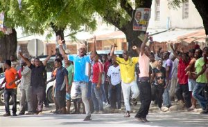 In this photo taken Monday, Oct. 26th, 2015 and made available Wednesday, Oct. 28th, 2015, youths supporting the opposition party dance and chant, predicting a win for their candidate, outside the Electoral Commission office in Stone Town, Zanzibar, a semi-autonomous island archipelago of Tanzania. Zanzibar's election commission chief announced Wednesday that the results of the island archipelago's presidential election have been nullified because of alleged irregularities, saying that the decision was taken because of several issues with the voting process, but did not say when another election would take place. (AP Photo)