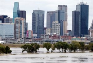 The rain-swollen Trinity River is seen with the city skyline in the background Saturday, Oct. 24, 2015, in Dallas. Southeast Texas was bracing for heavy rain late Saturday and into Sunday as the remnants of Hurricane Patricia combined with a powerful storm system that's been moving across Texas, flooding roads and causing a freight train to derail. (AP Photo/Tony Gutierrez)