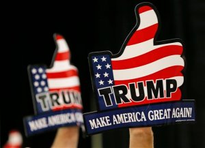 A group of supporters wave signs prior to a speech by Republican presidential hopeful Donald Trump during a rally in Richmond, Va., Wednesday, Oct. 14, 2015.  (AP Photo/Steve Helber)