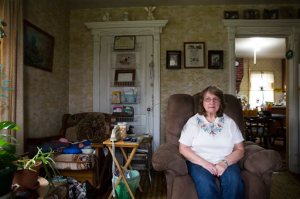 In this Friday, Oct. 9, 2015, photo, Carol Mead poses for a portrait at her home, in Montrose, Pa. Mead, 67, is retired and her husband, 70, must work at a local rock quarry to close the gap from her Social Security. For just the third time in 40 years, millions of Social Security recipients, disabled veterans and federal retirees can expect no increase in benefits next year, unwelcome news for more than one-fifth of the nation's population. (AP Photo/Brett Carlsen)