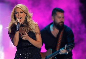 FILE - In this June 10, 2015, file photo, Carrie Underwood performs at the CMT Music Awards at Bridgestone Arena in Nashville, Tenn. Selena Gomez, Underwood and 5 Seconds of Summer will be performing at the American Music Awards, on Nov. 22, 2015, at the Microsoft Theater in Los Angeles. (Photo by Wade Payne/Invision/AP, File)