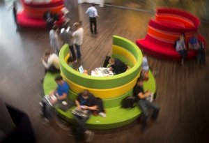 In this photo taken on Friday, Sept.  25, 2015, Mail.Ru Group employees work in a hall in their office building in Moscow, Russia. Mail.Ru Group is an the largest Internet company in the Russian-speaking world operates social networking sites, IM networks, email services, and internet portals. The government have pushed through a slew of new laws to strengthen its control over the Internet, which President Vladimir Putin has described as a CIA project. Some of the laws, including those giving the government broad leeway to block websites and blogs, have proven possible to get around. (AP Photo/Alexander Zemlianichenko)