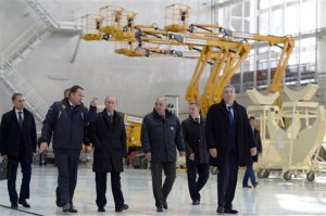 Russian President Vladimir Putin, third left, escorted by Russian Federal Space Agency head Igor Komarov, second left, walks through a working hall while visiting the Vostochny Cosmodrome near Uglegorsk, the city in eastern Siberia in the Amur region, Russia, Wednesday, Oct. 14, 2015. Putin has chided officials for a four-month delay in building a sprawling space center in the Far East. (Alexei Nikolsky, RIA-Novosti, Kremlin Pool Photo via AP)