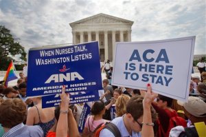 FILE - In this June 25, 2015, file photo, supporters of the Affordable Care Act hold up signs as the opinion for health care is reported outside of the Supreme Court in Washington. Opponents of President Barack Obama's health care overhaul are taking yet another challenge to the law to the Supreme Court. And they say they'll be back with more if this one fails. A new appeal being filed Monday, Oct. 26, contends the law violates the provision of the Constitution that requires tax-raising bills to originate in the House of Representatives.  (AP Photo/Jacquelyn Martin, File)