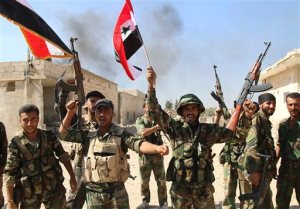 FILE - In this file photo taken on Sunday, Oct. 11, 2015, Syrian soldiers waving Syrian flags celebrate the capture of Achan, Hama province, Syria. The ever-growing, secret defense budgets and poor oversight of militaries in the Middle East make them susceptible to corruption and more vulnerable to extremist violence, a watchdog group warned. (Alexander Kots/Komsomolskaya Pravda via AP, File)
