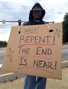 In this Monday, Sept. 21, 2015 photo released by the Somersworth Police Department, Officer Anthony McKnight poses undercover in Somersworth, N.H., with a sign, intending to catch violators of the states ban on the use of hand-held phones or electronic devices while driving. Nearly 100 drivers were ticked during the five-day sting, including a woman who was ticketed after giving in to her daughters pleas to snap a photo of the sign. (Matt Duval/Somersworth Police Department via AP)