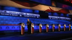 A crew member checks the candidate podiums at the venue for the Oct. 28 CNBC Republican presidential debate, Tuesday, Oct. 27, 2015, inside the Coors Events Center at the University of Colorado in Boulder, Colo. Republican presidential candidates taking the debate stage Wednesday in Colorado are hoping to carry momentum from a 2014 U.S. Senate victory in this toss-up state where independent voters outnumber the electorate from both major parties. (AP Photo/Brennan Linsley)