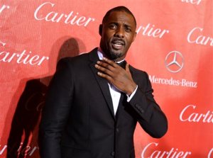 FILE- In this Jan. 4, 2014 file photo, Idris Elba arrives at the Palm Springs International Film Festival Awards Gala in Palm Springs, Calif. The spring exhibition at the Metropolitan Museum of Art's Costume Institute will focus on technology's impact on fashion, and the May 2, 2016 gala benefiting the institute will be co-chaired by Elba, Apple's chief design officer, Jonathan Ive, Taylor Swift and Anna Wintour. (Photo by Jordan Strauss/Invision/AP, File)