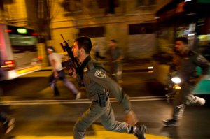 FILE - In a Wednesday, Oct. 14, 2015 file photo, Israeli policemen run looking for a possible stabbing suspect in Jerusalem. A sudden wave of stabbing attacks has spread fear in Jerusalem and much of Israel. (AP Photo/Dusan Vranic, File)