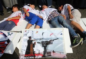 Lebanese boys depict Syrian boys who were killed by Russian airstrikes, during a sit-in in front the Russian embassy, in Beirut, Lebanon, Wednesday, Oct. 14, 2015. Moscow, which began its airstrikes in Syria on Sept. 30, said it is targeting Islamic State and other militant groups. But it has also struck positions of rebel groups supported by the West and other regional players. (AP Photo/Hussein Malla)
