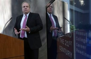 New Jersey Education Commissioner David C. Hespe addresses a gathering as the state releases results of student assessments from last spring's administration of a new standardized test Tuesday, Oct. 20, 2015, in West Trenton, N.J. Results released Tuesday from a new standardized test finds what others before it have: Less than half of New Jersey's public high school juniors are ready for college. (AP Photo/Mel Evans)