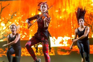 FILE - In this Sept. 25, 2015 file photo, Lindsey Stirling performs during the Life is Beautiful festival, in Las Vegas. YouTube's top-earning celebrity is Felix Kjellberg, better known by his handle "PewDiePie," a 25-year-old video-game-playing jokester who took in $12 million in the year ending June 1, 2015. Forbes magazine says he tops its first list of people who have spun short online videos into huge piles of cash. The dancing violinist Stirling ranked fourth on Forbes list with $6 million. (Photo by Paul A. Hebert/Invision/AP, File)