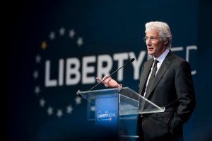 Actor, activist and philanthropist Richard Gere speaks during the Liberty Medal ceremony at the National Constitution Center, Monday, Oct. 26, 2015, in Philadelphia. The Dalai Lama, who canceled his public appearances this month because of health reasons is this year's recipient. The honor is given annually to an individual who displays courage and conviction while striving to secure liberty for people worldwide. (AP Photo/Matt Rourke)