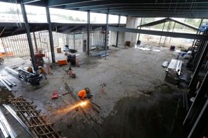 Sparks fly as a worker cuts steel rebar during the construction of a new elementary school in Westport, Wash., Thursday, Oct. 8, 2015. The school is being built to serve a second role as a tsunami shelter, because Westport currently has no ground high enough to protect people from the high waters and debris that could come from an earthquake-generated tsunami. The reinforced rooftop will be large and strong enough to hold more than 1,000 people, and is designed to withstand an earthquake. (AP Photo/Ted S. Warren)