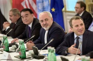 Chinese Vice Minister of Foreign Affairs Li Baodong, second left, and Iranian Foreign Minister Mohammad Javad Zarif, second right, wait with others for the start of talks on Syria at a hotel in Vienna, Austria, Friday, Oct. 30, 2015. US Secretary of State John Kerry is acknowledging that progress will be difficult as he launches a marathon day of talks aimed at ending the Syrian War but is expressing some hope of headway. With 19 foreign ministers and other senior dignitaries attending, participants say the fact that the talks are happening despite deep divisions among key players are in themselves a sign of success. (Brendan Smialowski/Pool Photo via AP)