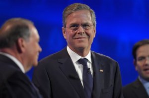 Jeb Bush, center, stands with Mike Huckabee, left, and Marco Rubio during the CNBC Republican presidential debate at the University of Colorado, Wednesday, Oct. 28, 2015, in Boulder, Colo. (AP Photo/Mark J. Terrill)