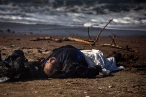 The body of a dead man lays on a beach in Petra village on the northeastern Greek island of Lesbos, Friday, Oct. 30, 2015. The deaths occurred amid a surge of crossings to Greek islands involving migrants and refugees from Syria, Afghanistan and other countries ahead of winter and as European governments weight taking tougher measures to try and limit the number of arrivals in Europe. (AP Photo/Santi Palacios)
